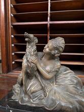 Antique style Statue og a reclining woman and a dog